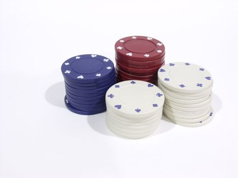 Assorted coloured poker chips stacked in a group