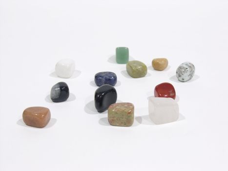 Multi-coloured stone charms on a white surface