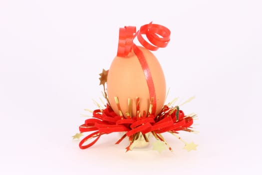 Chicken egg with decorations with red band