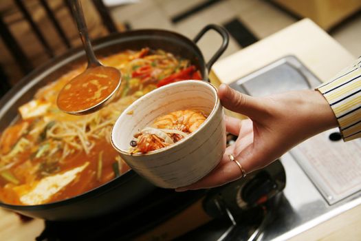 Delightful healthy Asian kitchen - magnificent and nutritious Korean soup with noodles and seafoods