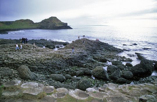 Tourists explore the Giant's Causeway, Northern Ireland's biggest attraction.