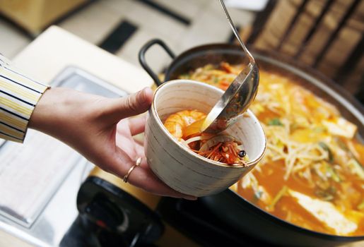 Delightful healthy Asian kitchen - magnificent and nutritious Korean soup with noodles and seafoods