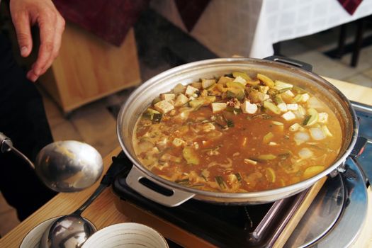 Delightful healthy Asian kitchen - magnificent and nutritious Korean soup with noodles and seafoods