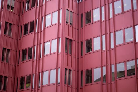Detail of windows in a modern red office building in Rotterdam, the Netherlands. 