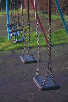 row of childrens swings