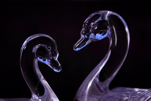 pair of beautiful prurple glass swans