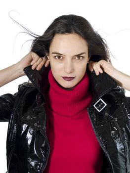 Portrait of a beautiful model holding her black leather jacket over white background.