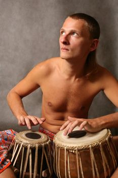 Man playing the nigerian drum in studio