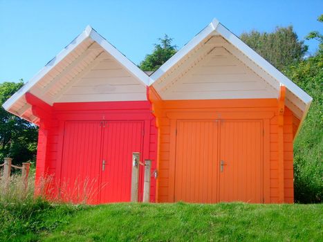 Exteriors of beautiful bright seaside beach chalets, Scarborough, England.