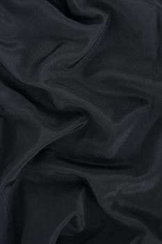 Black satin fabric. Abstract background.