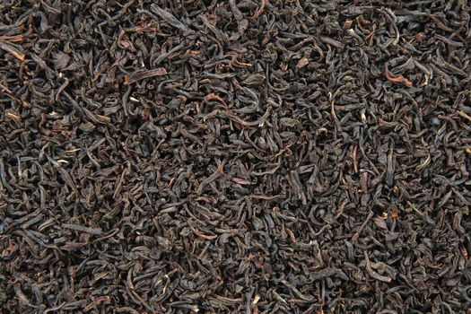 Black tea leaves background. Abstract food textures.