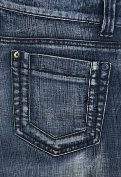Closeup of blue denim jeans pockets.