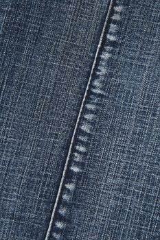 Blue denim fabric with stitch. Abstract background.