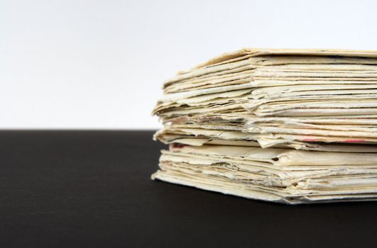 Stack of old letters on black and white background.