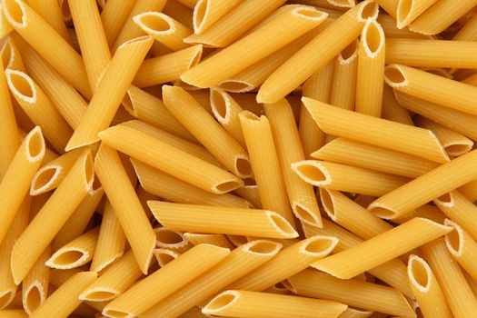 Penne rigate pasta background. Abstract food textures.