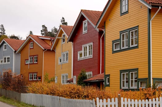 A row of residential houses, painted in various colours
