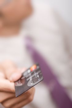 Business man holding credit card, shallow DOF.