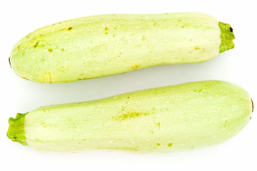 Two vegetable marrows on a white background.