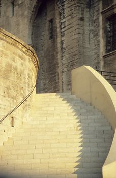 Stairs of the Papal Palace in Avignon, France in shadow and light.