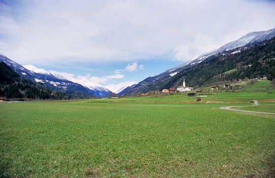 A tiny rural village sits below the snow line in the Austrian Alps.