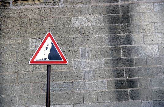 A warning sign beside the Avignon city walls. Danger Falling Rocks!