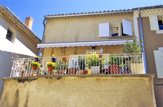 A terras decorated with colourful potted flowers, Gigondas, France.