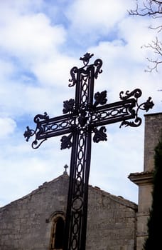 A wrought iron cross welcomes people to the chaple in Les Baux de Provence.