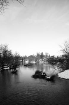 A black and white image of a lake in winter