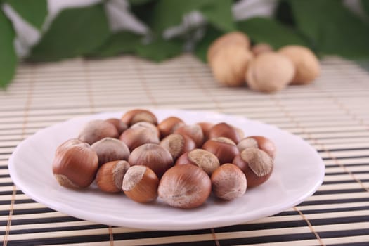 Wood nuts in a cup, removed against walnuts