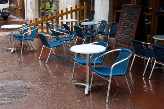 Empty street cafe on a rainy day at Annecy, France