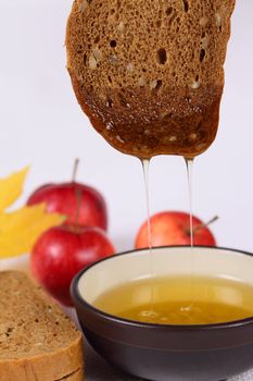 Bread, honey and apples removed close up on a linen napkin