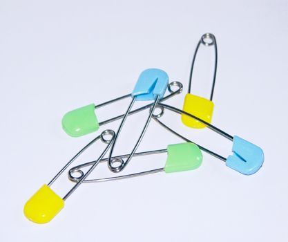 The image of six multi-coloured children's pins.