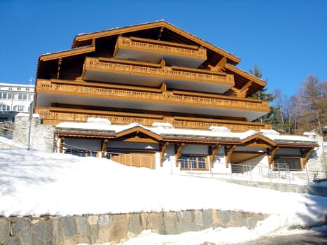 Exterior architecture of Swiss Ski chalety in winter snow.