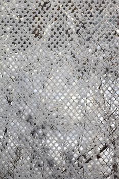 Metal grid covered by a snow removed close up