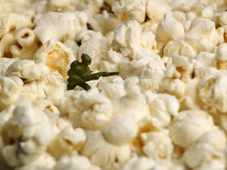 A toy soldier scouting among a popcorn field.