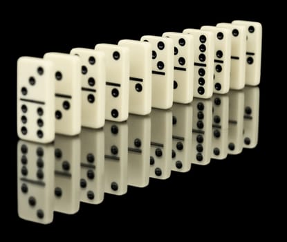 Chips dominoes ranked on a black background with reflection
