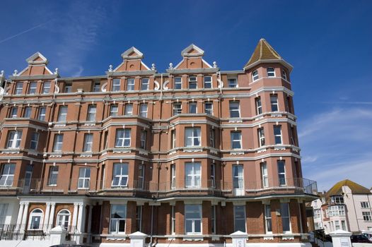 A row of victorian townhouses with a blue sky