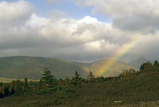 A rainbow points the way to heaven on an autumn day in Cape Breton, Nova Scotia, Canada.