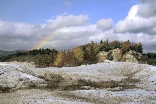 A rainbow hangs above the strange landscape of a chalk mine in Cape Breton, Nova Scotia. 