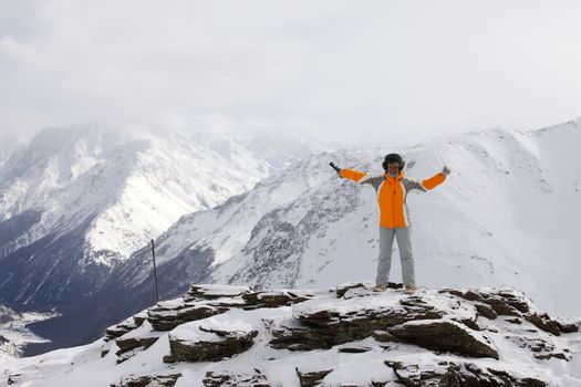 The cheerful woman with an icicle on a hill of mountain