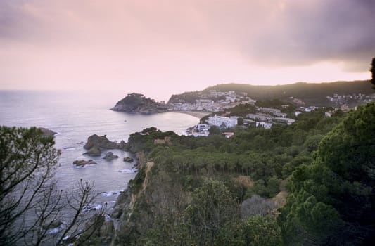 The sun sets over a resort town on Spain's Costa Brava.
