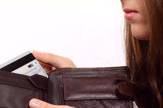 The girl with a purse and a bank card removed close up