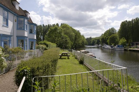 A nice blue and white house by a river