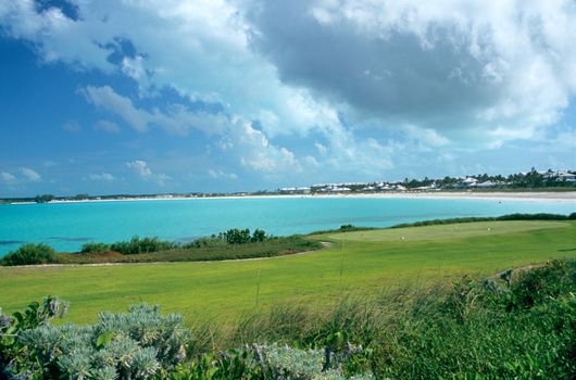 A golf course in the Bahamas overlooks a tropical beach resort.