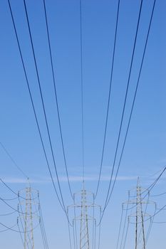 Three pylons with power lines stretching from them
