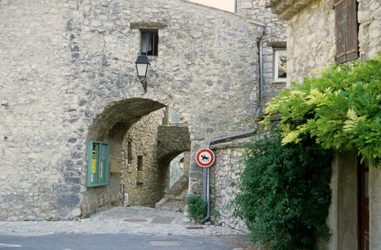 A no horses sign on an ancient stone wall in the south of France. 