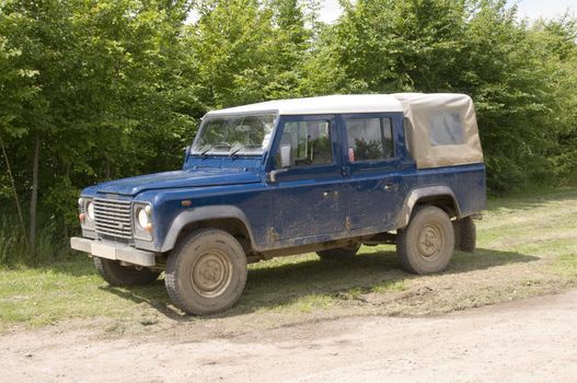 A four wheel drive truck on a farm track