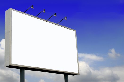 Blank Billboard  with lamps and blank screen for commercial use, in a beautiful blue sky background
