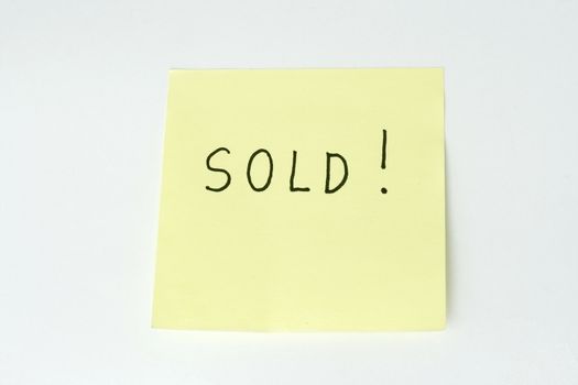 sticky post it note with sold wording
