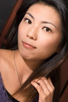Attractive Asian beauty portrait with black hair and yellow skin.